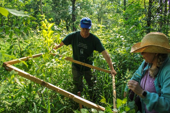 Ken and Pati mark a plot with the quadrat. Photo © Lake County Forest Preserves.