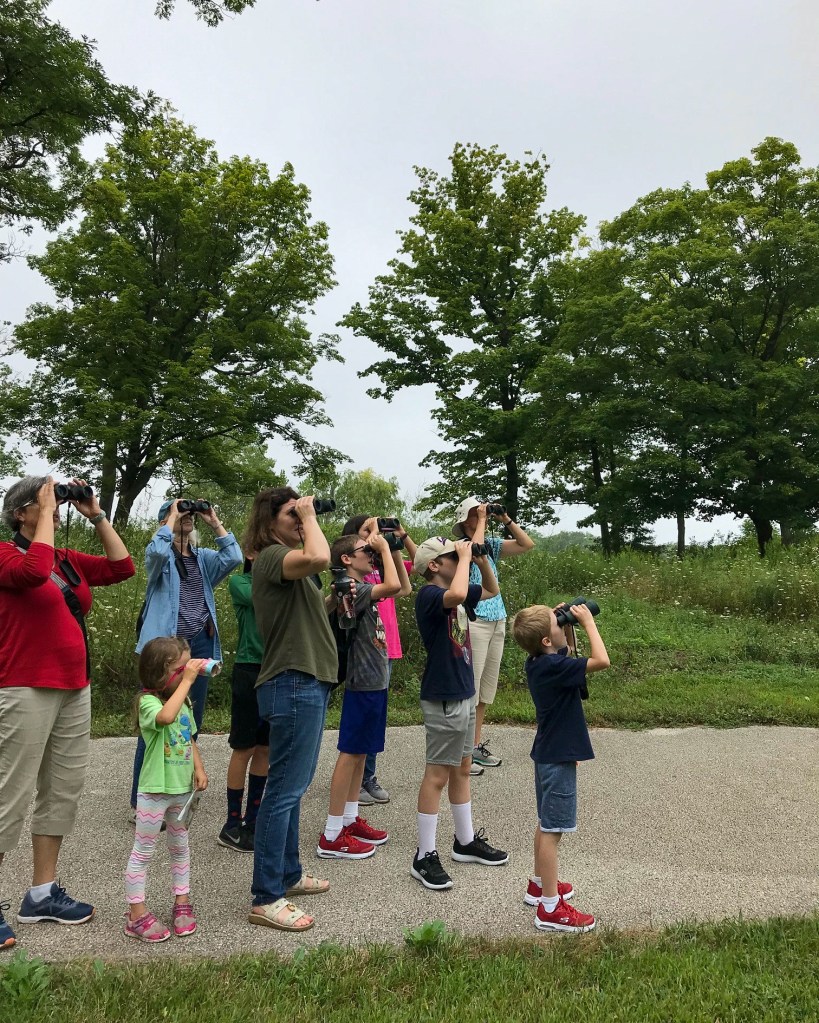 A group of preserve visitors watches for birds. Photo © Lake County Forest Preserves.