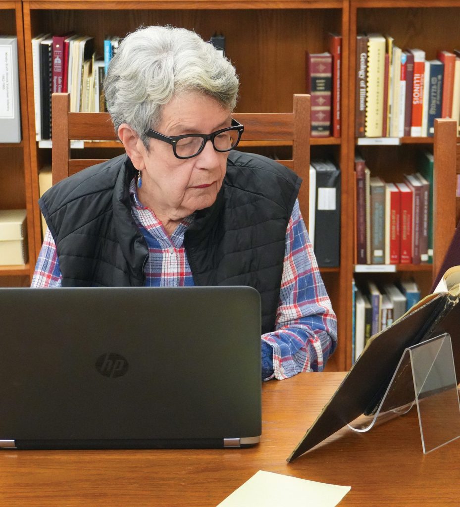 Dunn Museum volunteer Barbara Johnson decodes and digitizes documents written in cursive.