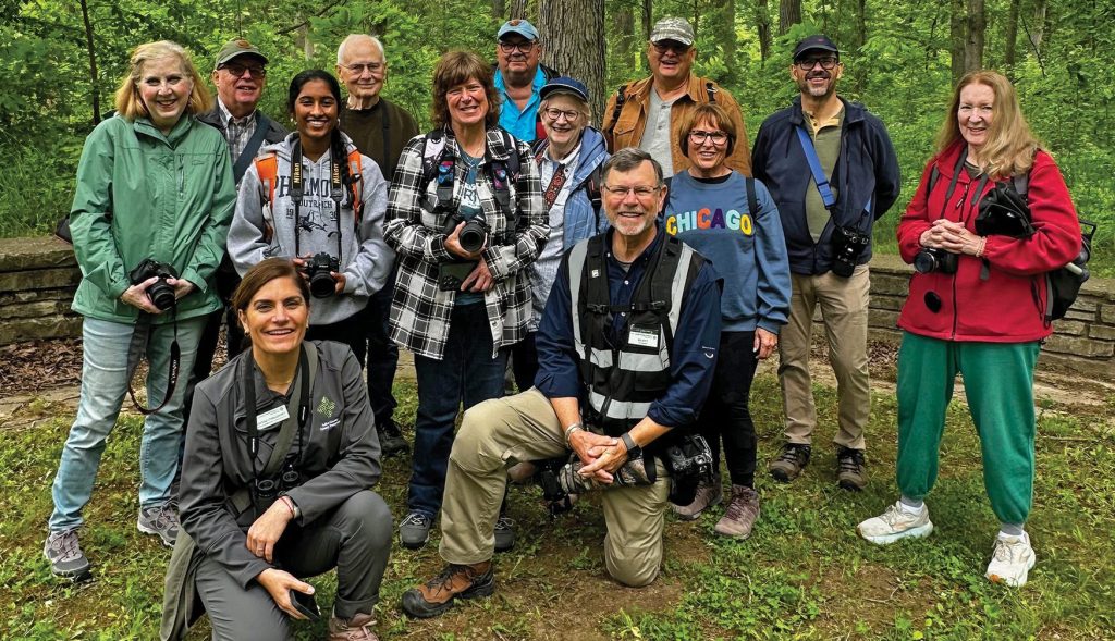 Volunteer photographer R. Scott McNeill (center, wearing black vest) and environmental educator Anissa Chaudhry (lower left, wearing gray jacket) teaching a Photography in the Forest Preserves program.